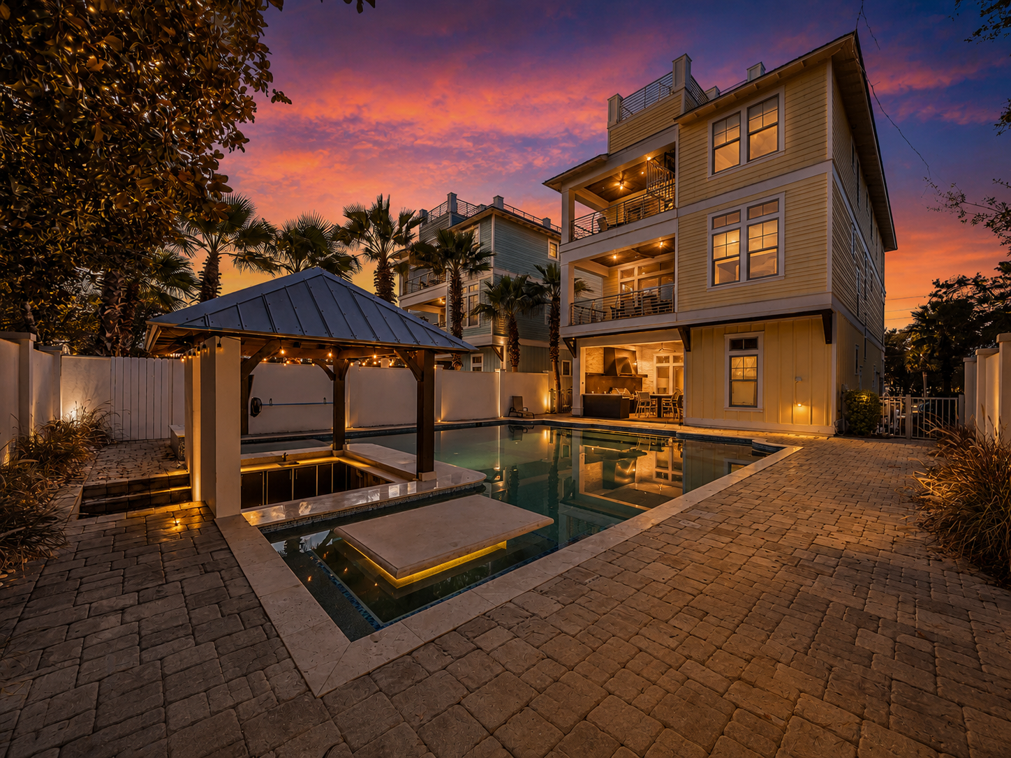 Luxury coastal home with pool and outdoor living space at sunset along 30A in Santa Rosa Beach, Florida