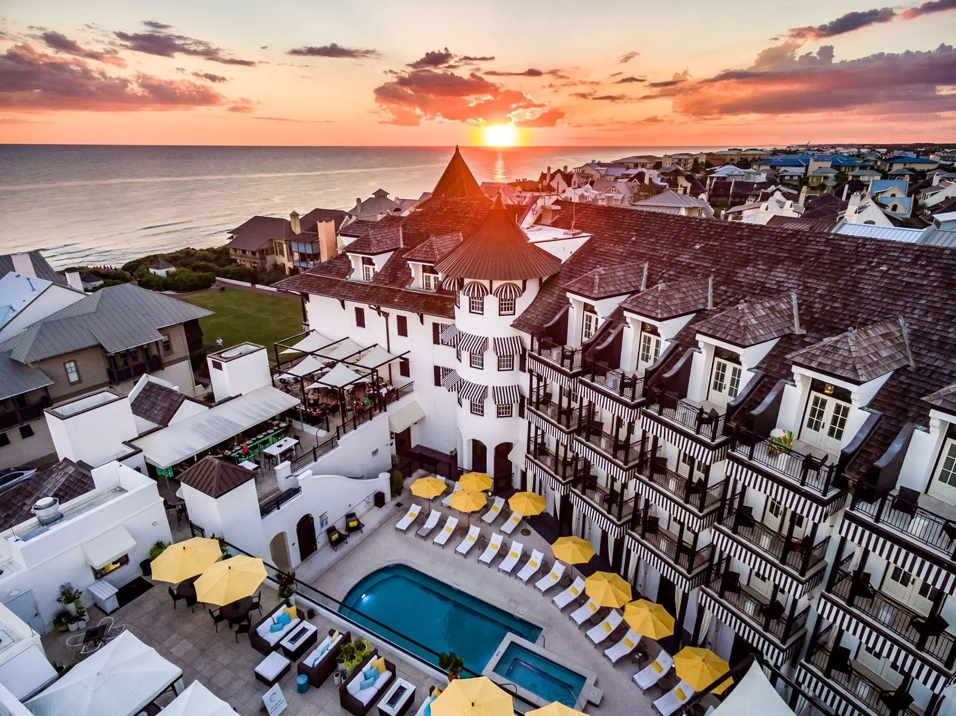 Aerial sunset view of Rosemary Beach with the Pearl hotel, pool, and Gulf of Mexico, 30A, FL