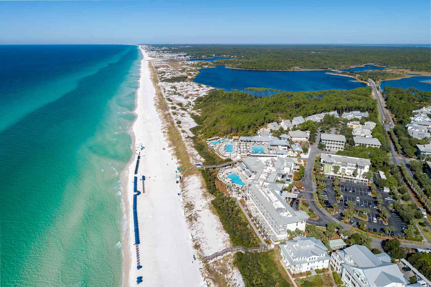 Aerial view of WaterColor along Scenic 30A with white sand beach, emerald Gulf water, and coastal neighborhoods, FL